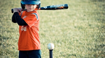 A child takes a swing at T-ball practice