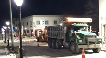 A dump truck parked on Washington Avenue as construction work takes place