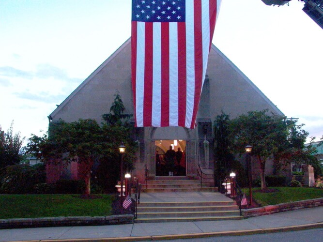 A U.S. flag hangs outside the entrance of Holy Child church.