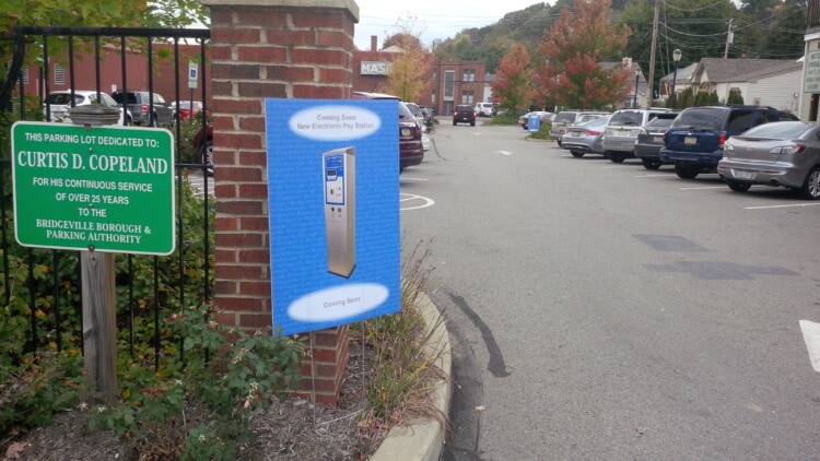 A sign in front of Bridgeville's Parking Lot #1 notes that electronic pay stations are coming.