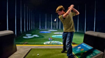 A visitor to the Alpharetta, Georgia Topgolf takes swings at the driving range