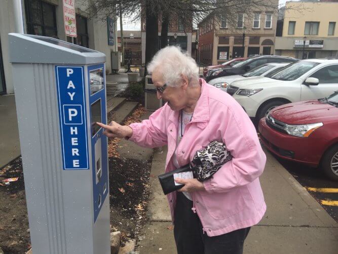 Marjorie Jablonski demonstrates the trouble she was having with a Bridgeville parking kiosk