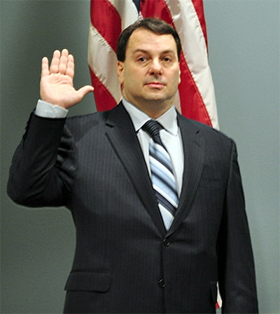 Bridgeville Mayor Pat DeBlasio stands with his right hand in the air as he is sworn in to his first term in January 2014.