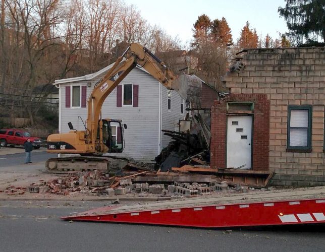 A bulldozer is shown demolishing the building at 686 Baldwin Street in Bridgeville, PA.